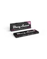Two Blazy Susan ultra-thin rice rolling paper packs, one standing and one lying flat at an angle